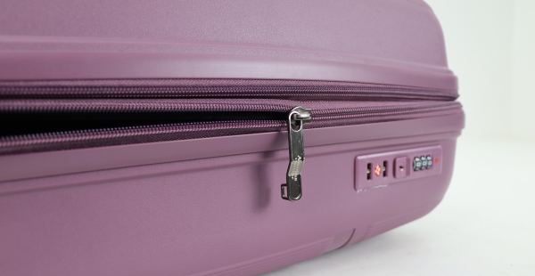 Close-up of a premium double zipper with built-in TSA Type lock on a travel suitcase